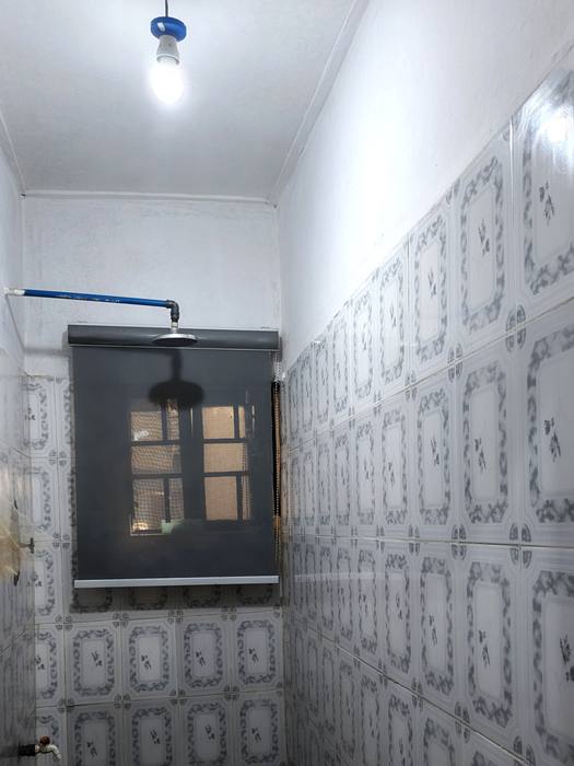 Tiled bathroom with overhead shower